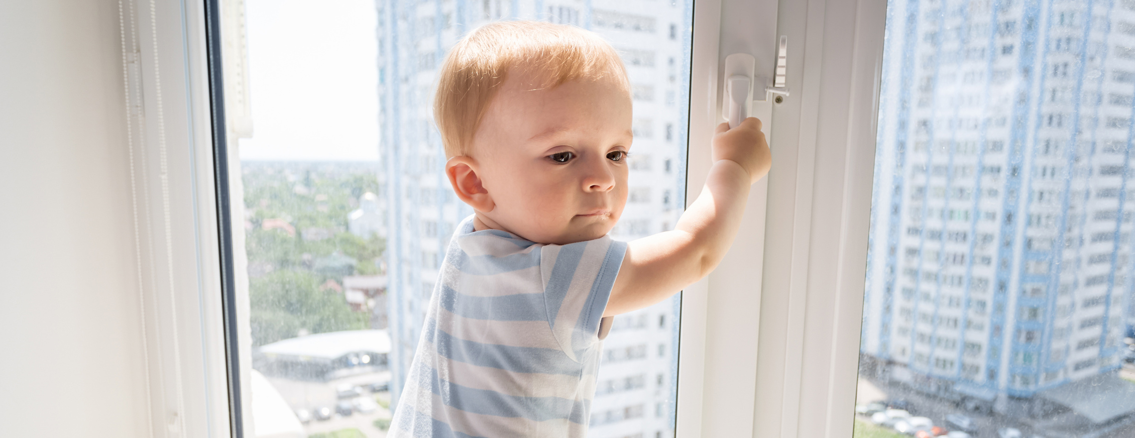 Kleiner Junge klettern an einem Fenster herum